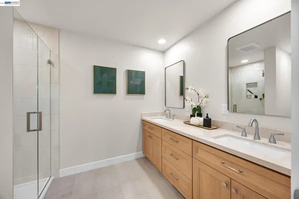 a bathroom with double sink and a mirror