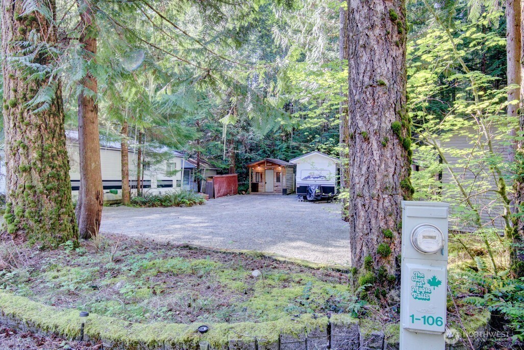 106 Goldrush Road Deming, WA 98244 - Photo 23 of 35 a backyard of a house with outdoor seating and trees