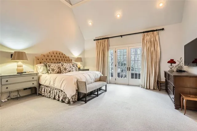 a spacious bedroom with a bed and large window