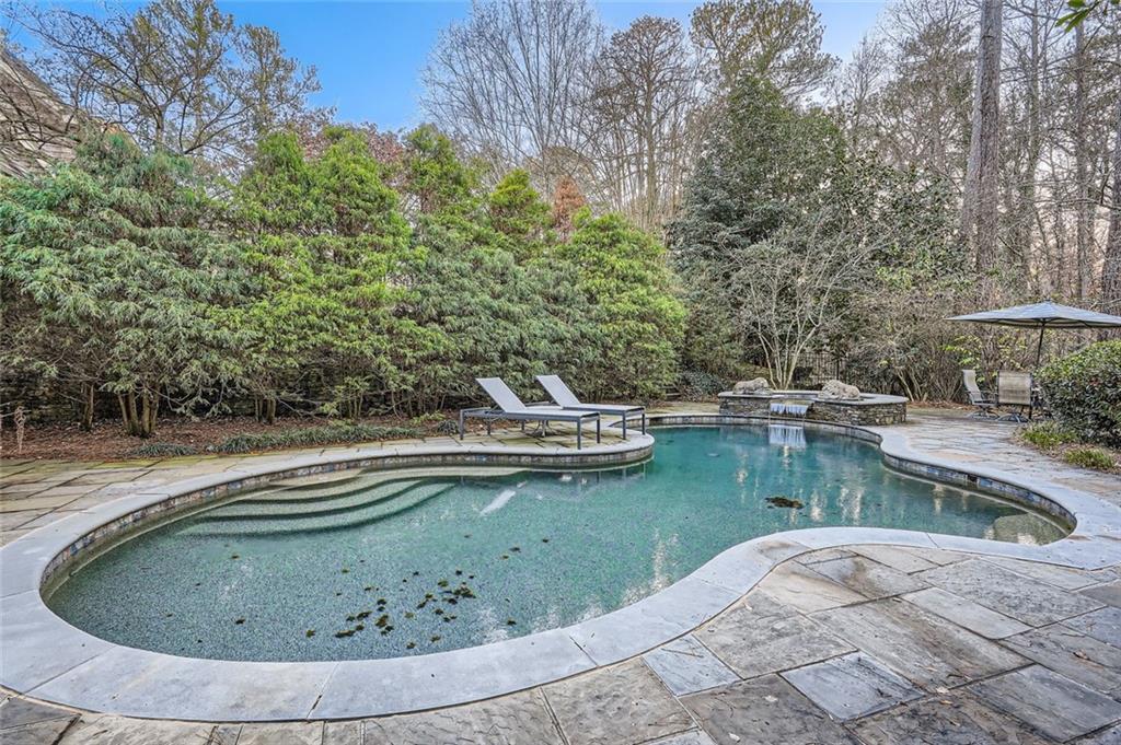 4340 Garmon Road Northwest Atlanta, GA 30327 - Photo 33 of 36 a view of a swimming pool with lawn chairs and plants
