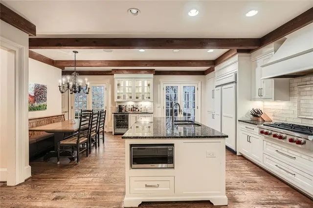 a kitchen with stainless steel appliances granite countertop a stove and a refrigerator