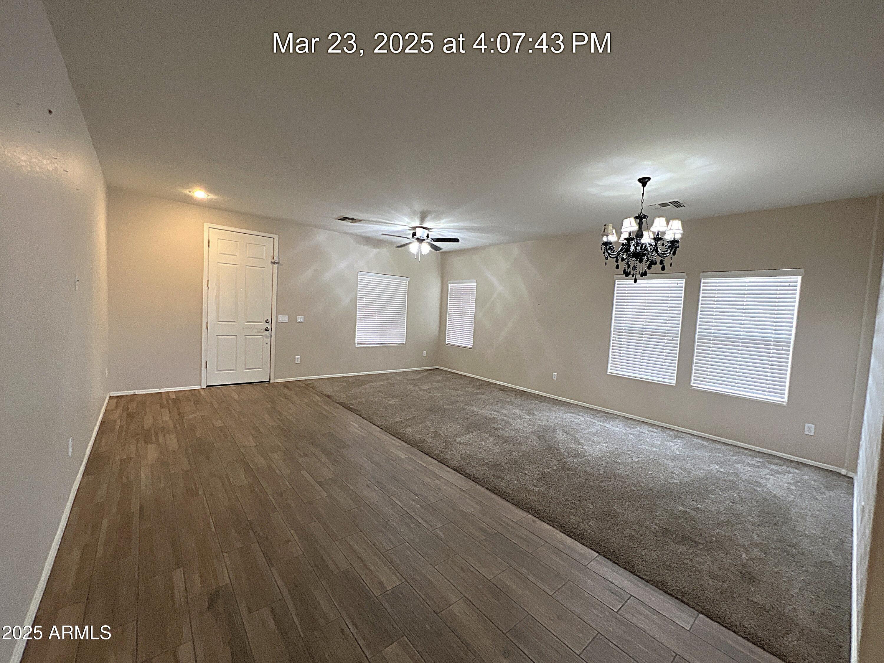 21183 East Avenida Del Valle Queen Creek, AZ 85142 - Photo 11 of 29 a view of a chandelier fan and wooden floor