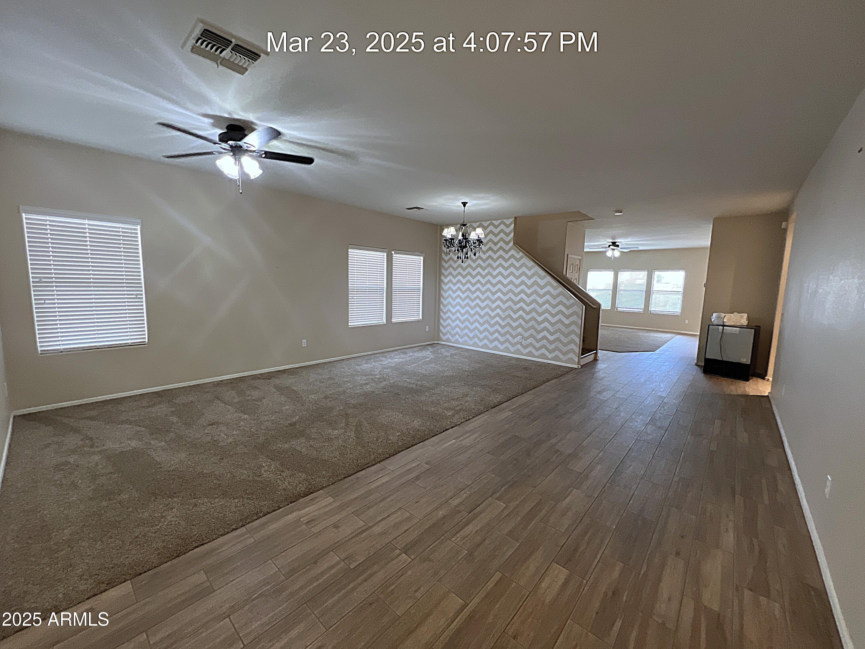 21183 East Avenida Del Valle Queen Creek, AZ 85142 - Photo 12 of 29 wooden floor in an empty room with a window
