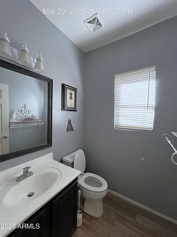 a bathroom with a sink mirror and toilet