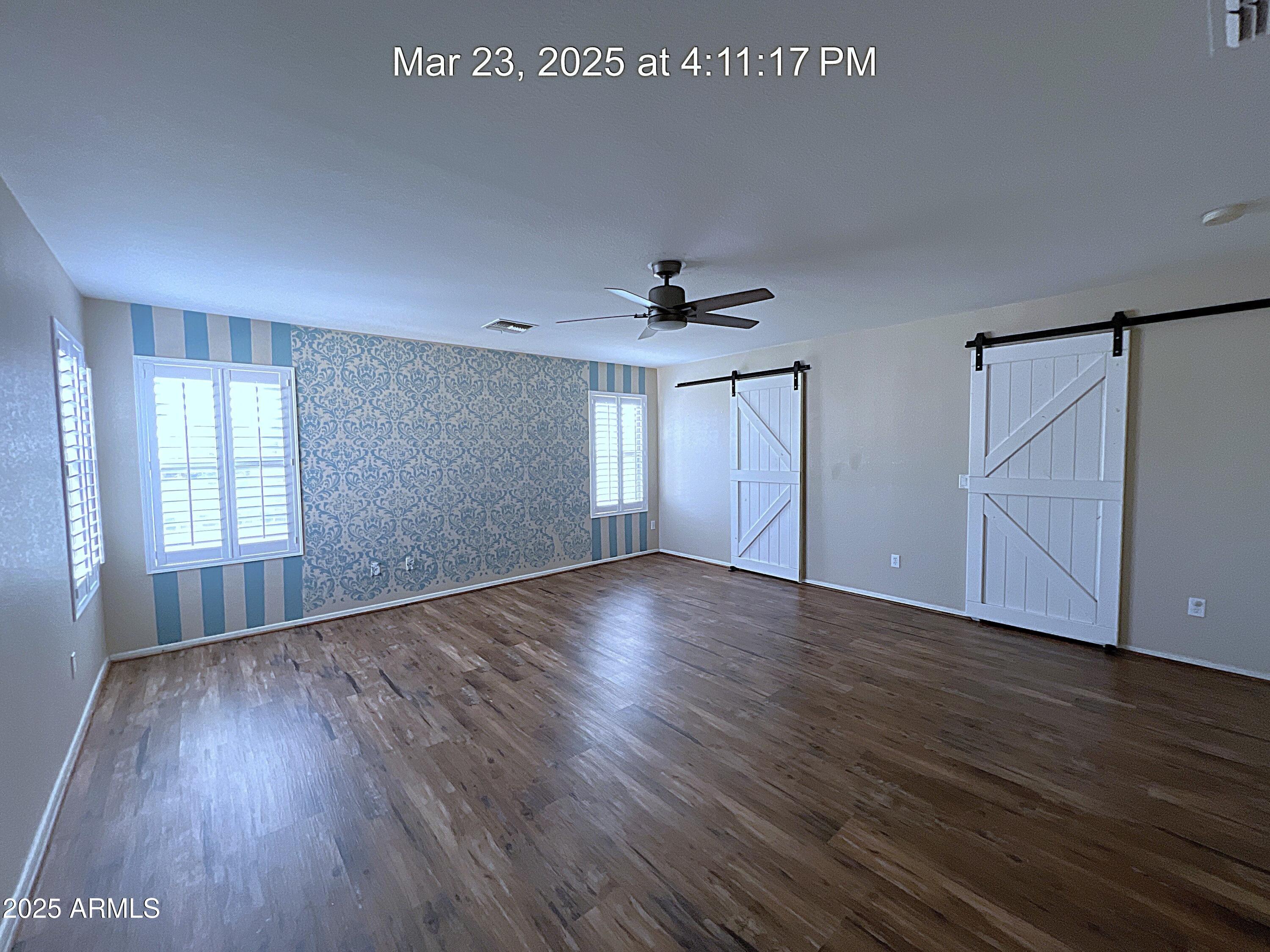 21183 East Avenida Del Valle Queen Creek, AZ 85142 - Photo 20 of 29 a view of an empty room with wooden floor and a window