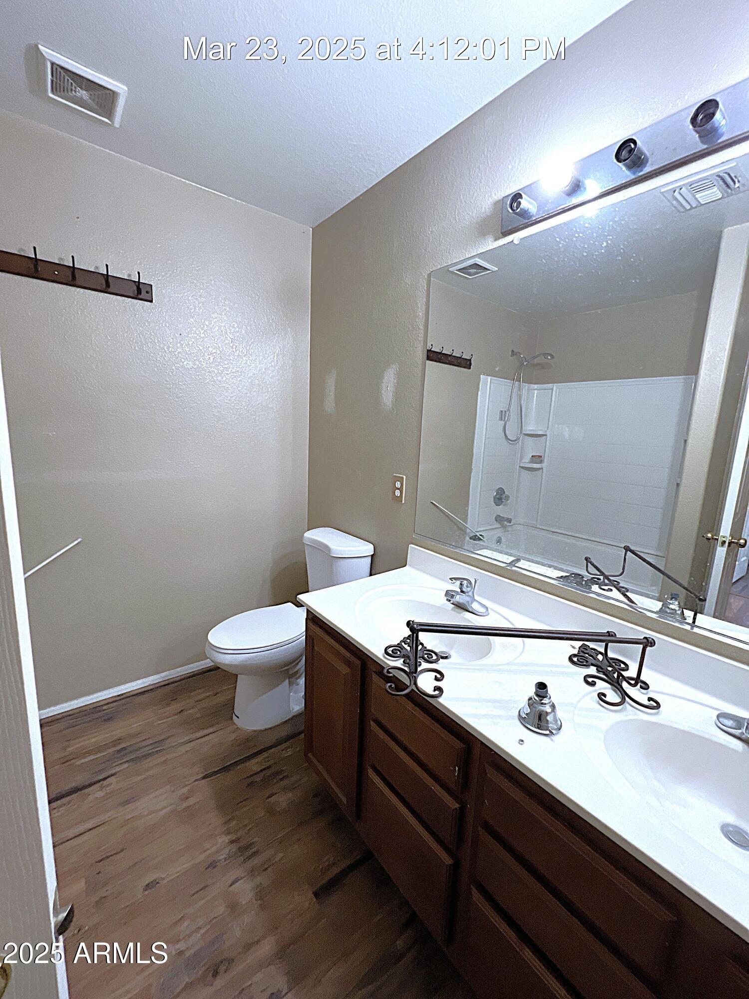 21183 East Avenida Del Valle Queen Creek, AZ 85142 - Photo 22 of 29 a bathroom with a sink a toilet and a mirror