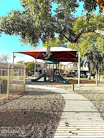 a view of a park with iron fence