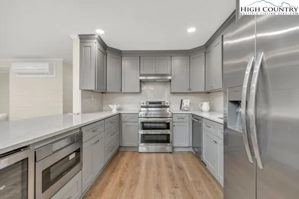 a kitchen with cabinets and stainless steel appliances