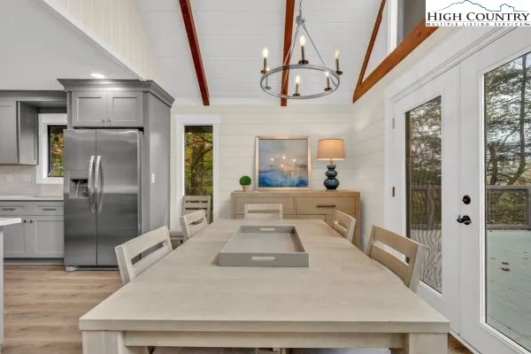 a large white kitchen with a large window