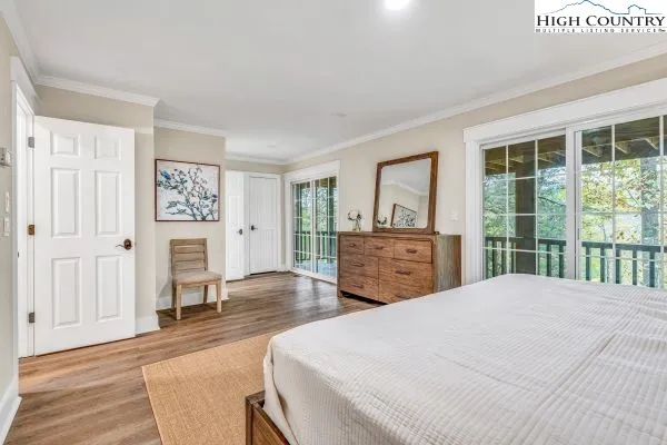 a spacious bedroom with a bed and a dresser