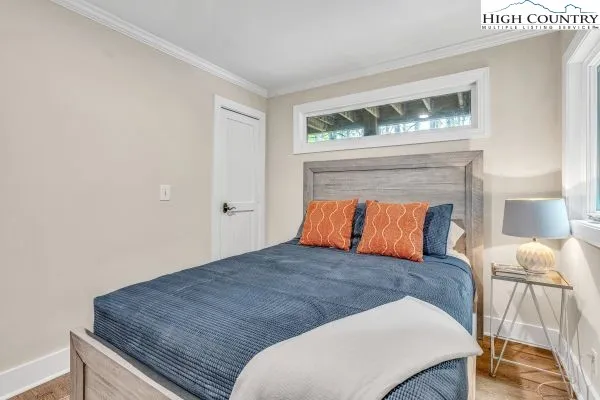 a bed sitting in a bedroom next to a lamp