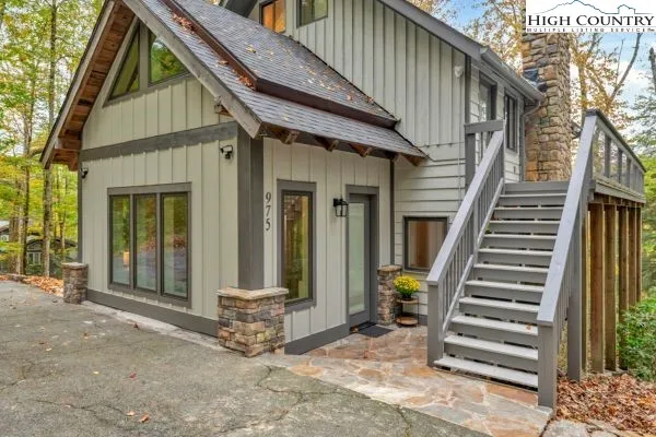 a view of a house with entryway and wooden fence