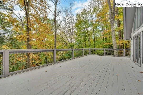 a view of a balcony with wooden floor and fence