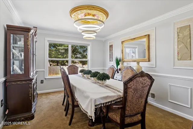 a view of a dining room with furniture a chandelier and wooden floor