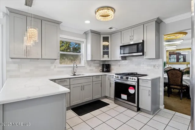 a kitchen with stainless steel appliances granite countertop a sink and cabinets