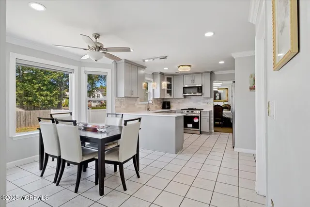 a kitchen with a dining table chairs and white appliances