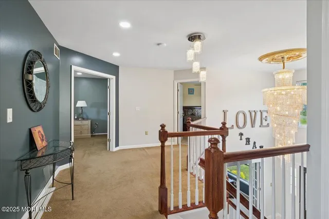 a view of a hallway to a livingroom with furniture and wooden floor