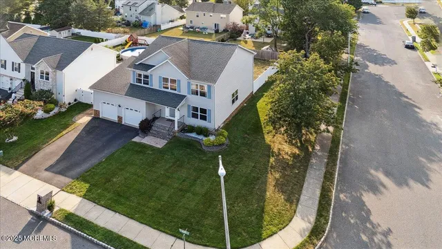 aerial view of a house with a yard