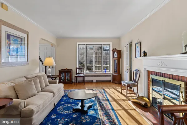 a living room with furniture fireplace and window