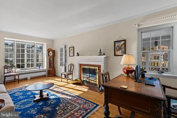 a living room with furniture a window and a fireplace