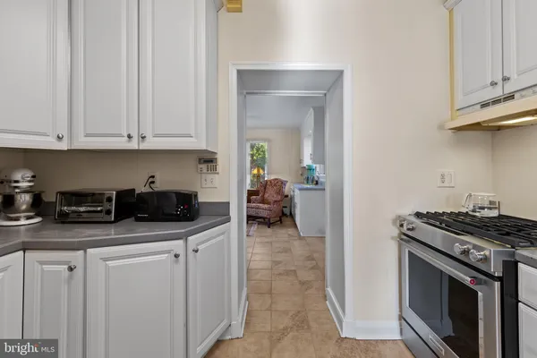 a kitchen with stainless steel appliances granite countertop a stove sink and cabinets