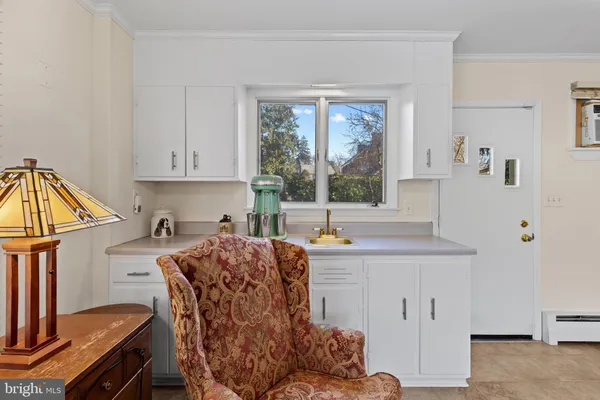 a view of a kitchen with a table and chairs in it