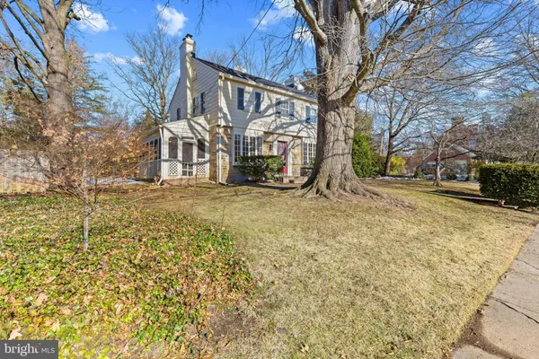 a view of a house with snow next to a road