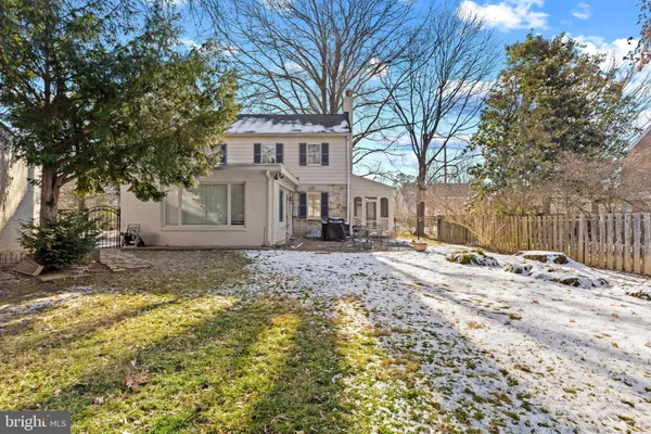 a view of a house with a yard covered in snow