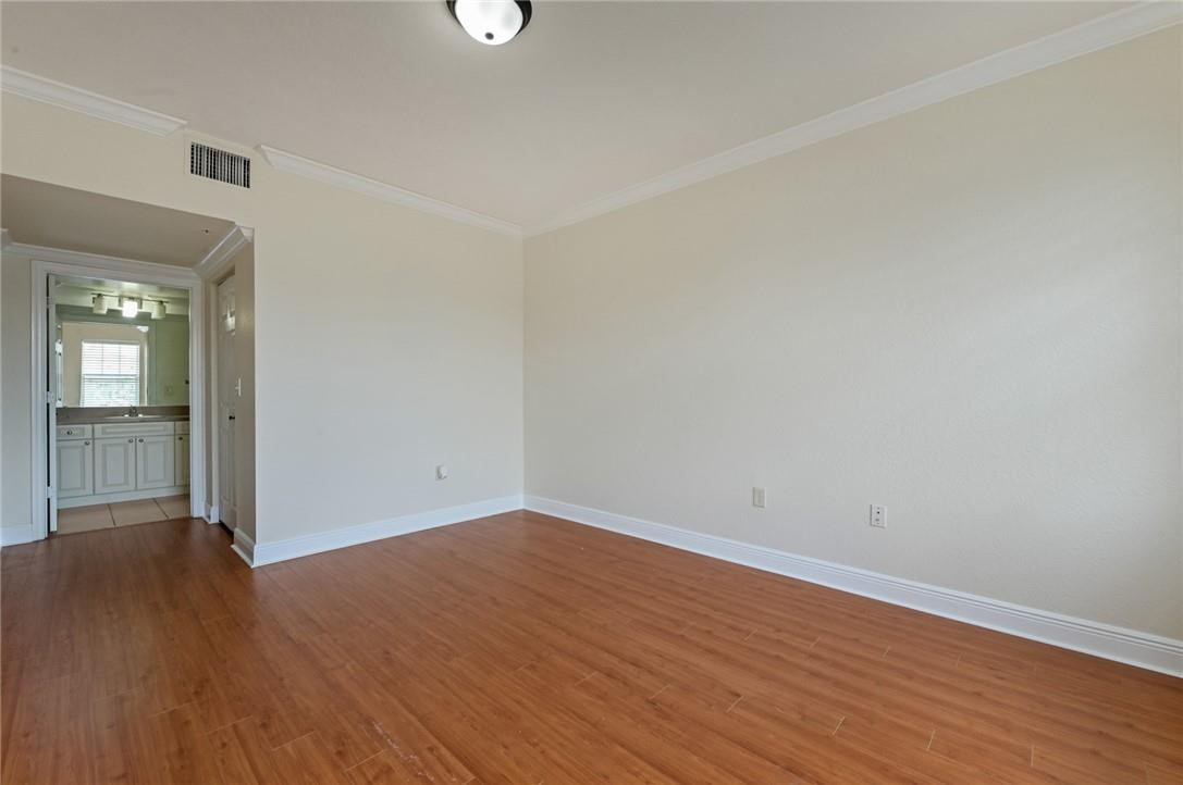 6348 West Sample Road, Unit 6348 Coral Springs, FL 33067 - Photo 15 of 25 Master suite has wood laminte flooring