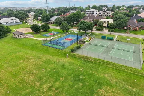 an aerial view of a house with a garden and swimming pool