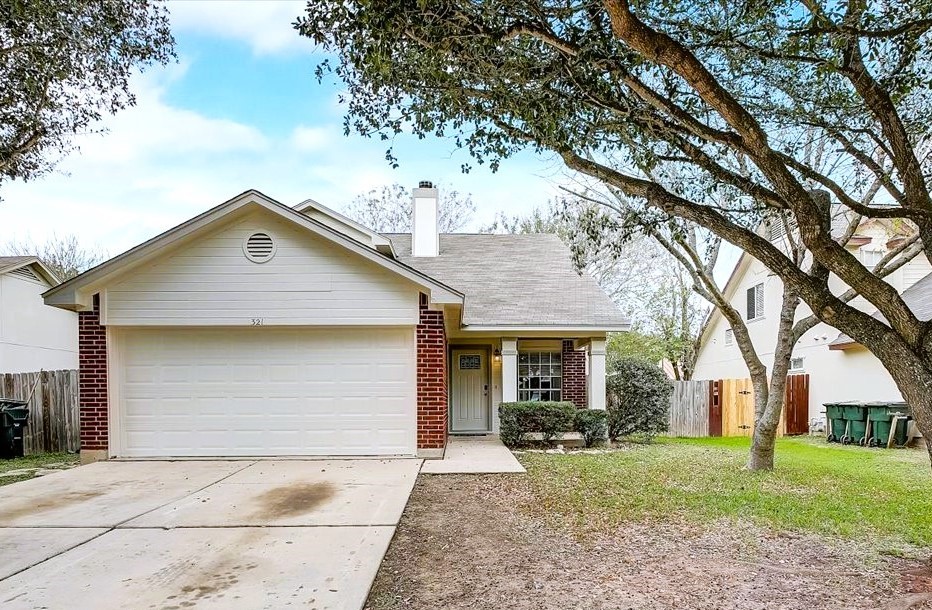 321 Zebra Drive Kyle, TX 78640 - Photo 1 of 1 a front view of a house with a yard and garage