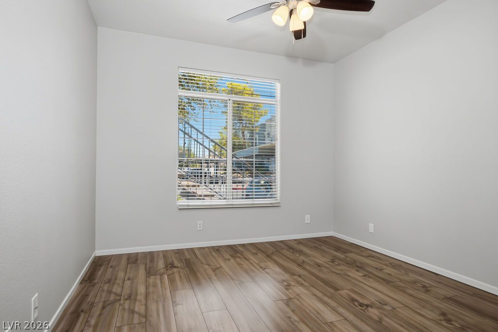 2201 Ramsgate Drive, Unit 514 Henderson, NV 89074 - Photo 15 of 28 Well-lit room with wood flooring and a ceiling fan, offering a comfortable living space.