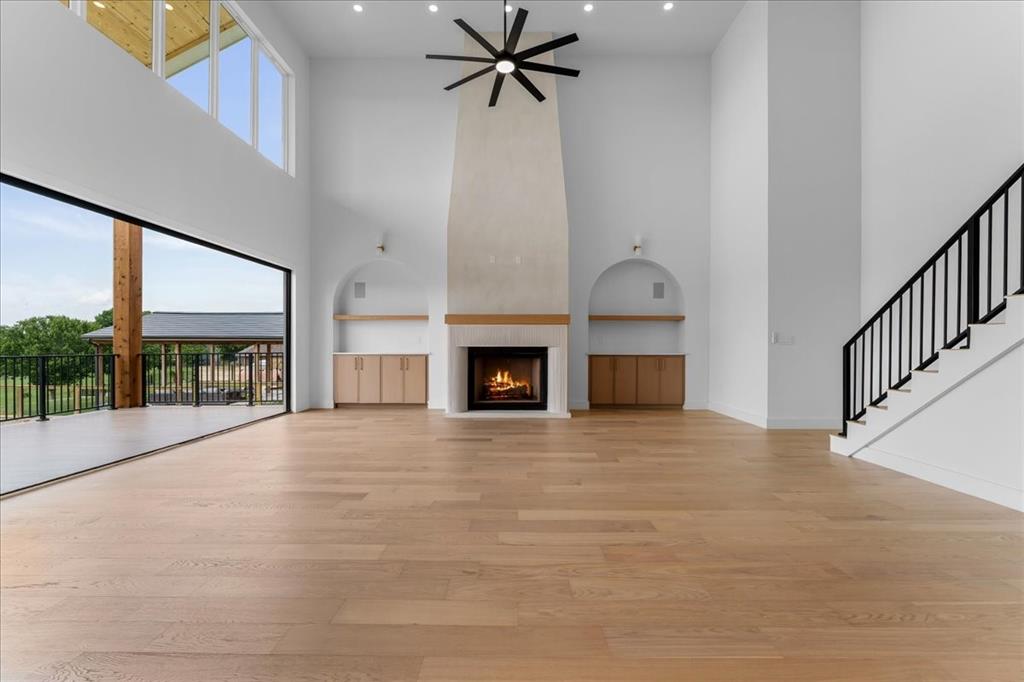 10576 Buccaneer Point Frisco, TX 75036 - Photo 5 of 40 a view of an empty room with a fireplace and windows
