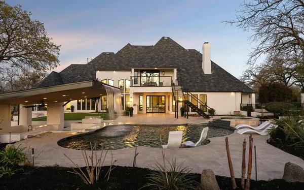 a front view of a house with a yard outdoor seating and garage