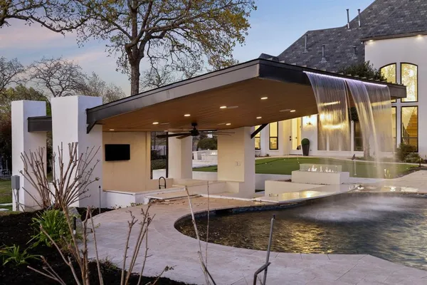 a swimming pool with outdoor seating and yard