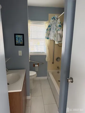 a bathroom with a sink a toilet and bathtub