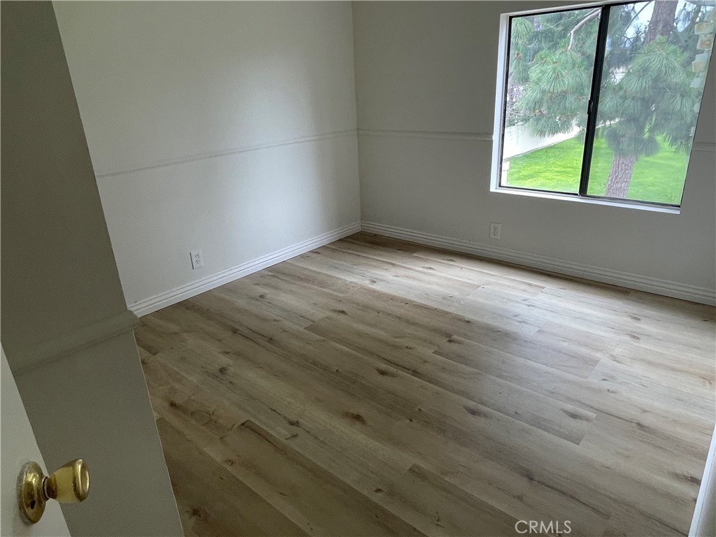 16 Gatewood Irvine, CA 92604 - Photo 11 of 12 an empty room with wooden floor and windows