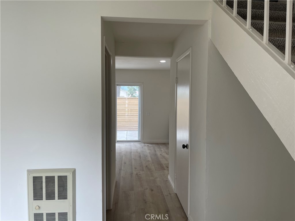 16 Gatewood Irvine, CA 92604 - Photo 3 of 12 a view of a hallway with wooden floor and a bathroom