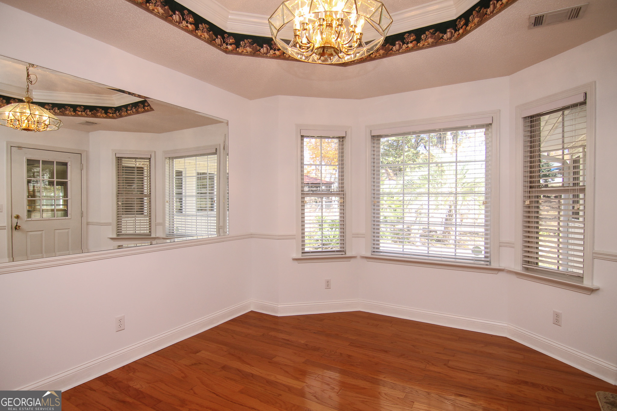 111 Maple Glen Centerville, GA 31028 - Photo 12 of 35 a view of an empty room with a window and wooden floor