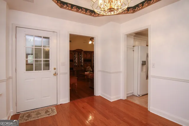 a view of a bedroom with wooden floor and closet