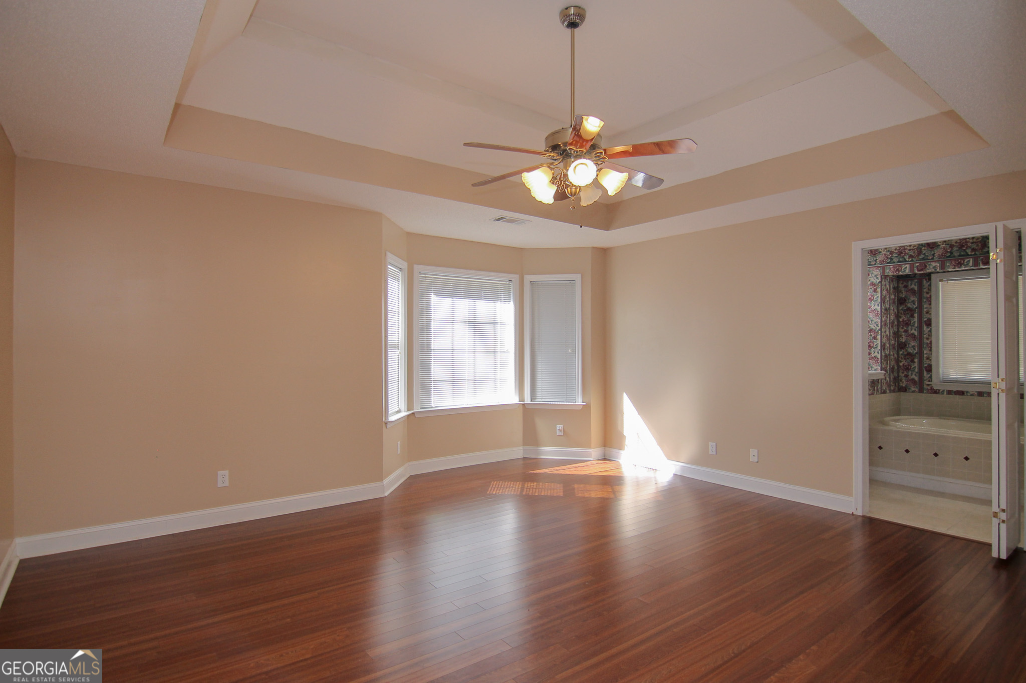 111 Maple Glen Centerville, GA 31028 - Photo 14 of 35 a view of an empty room with a window and wooden floor