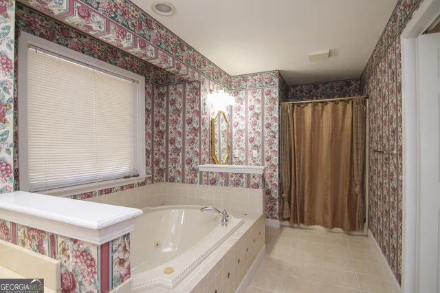 a bathroom with a bathtub and shower
