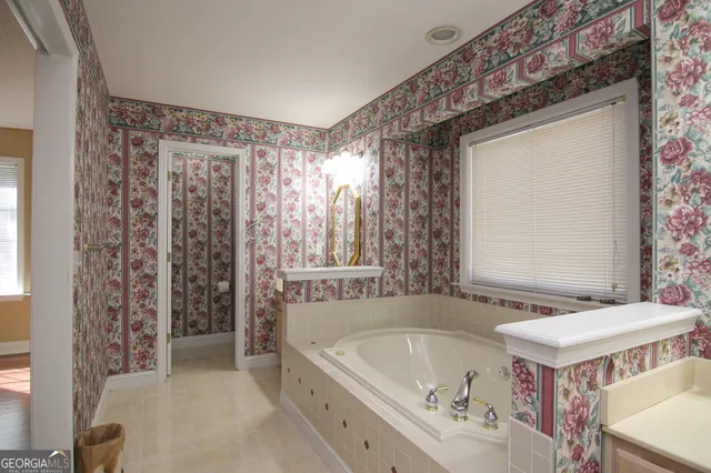 a spacious bathroom with a bathtub and a sink