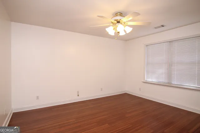 wooden floor in an empty room with a window