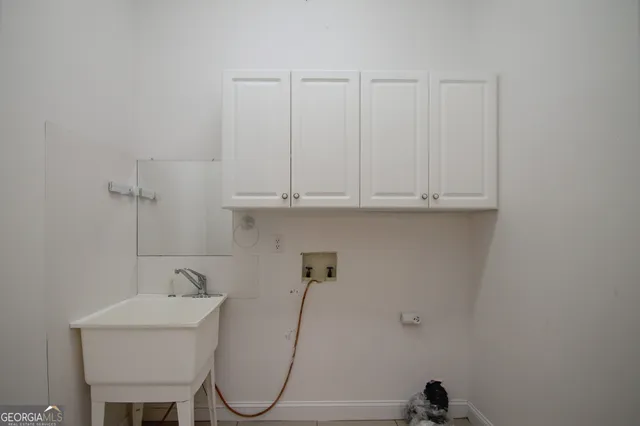 a bathroom with a sink and cabinets