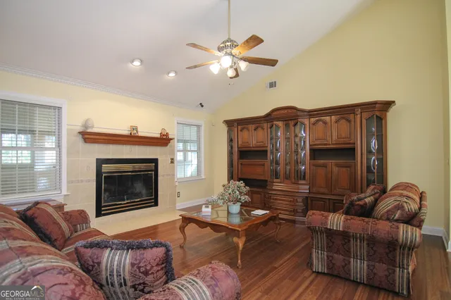 a living room with furniture and a fireplace