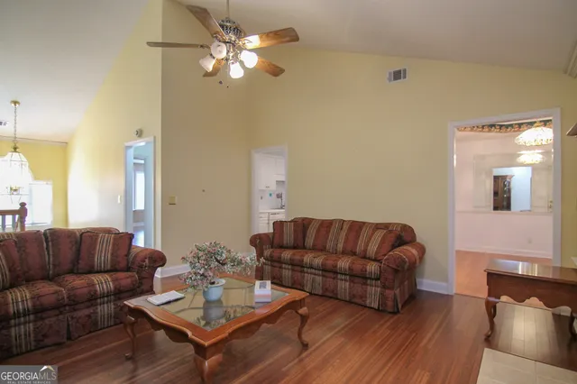 a living room with furniture a couch and a chandelier