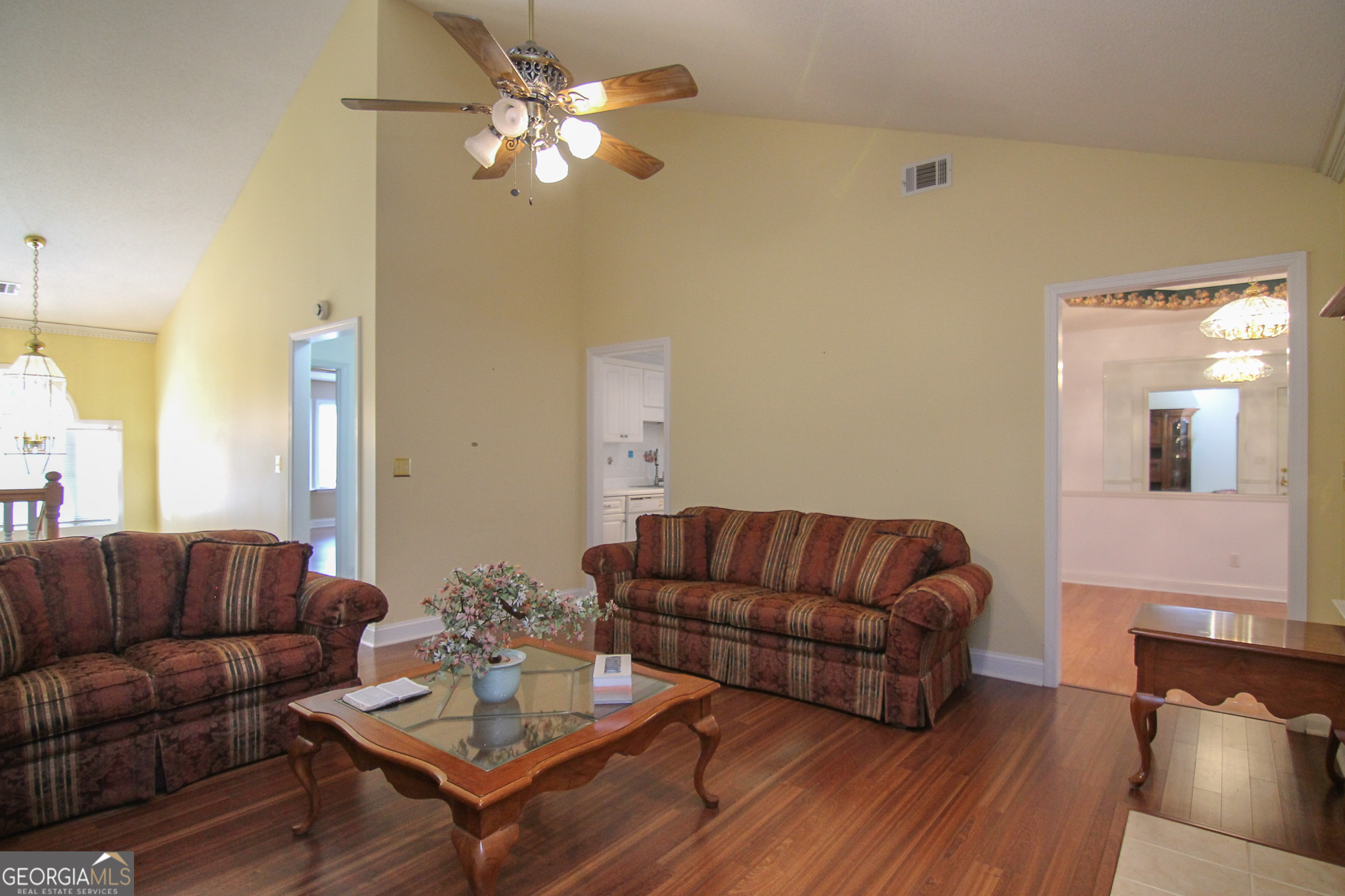 111 Maple Glen Centerville, GA 31028 - Photo 8 of 35 a living room with furniture a couch and a chandelier