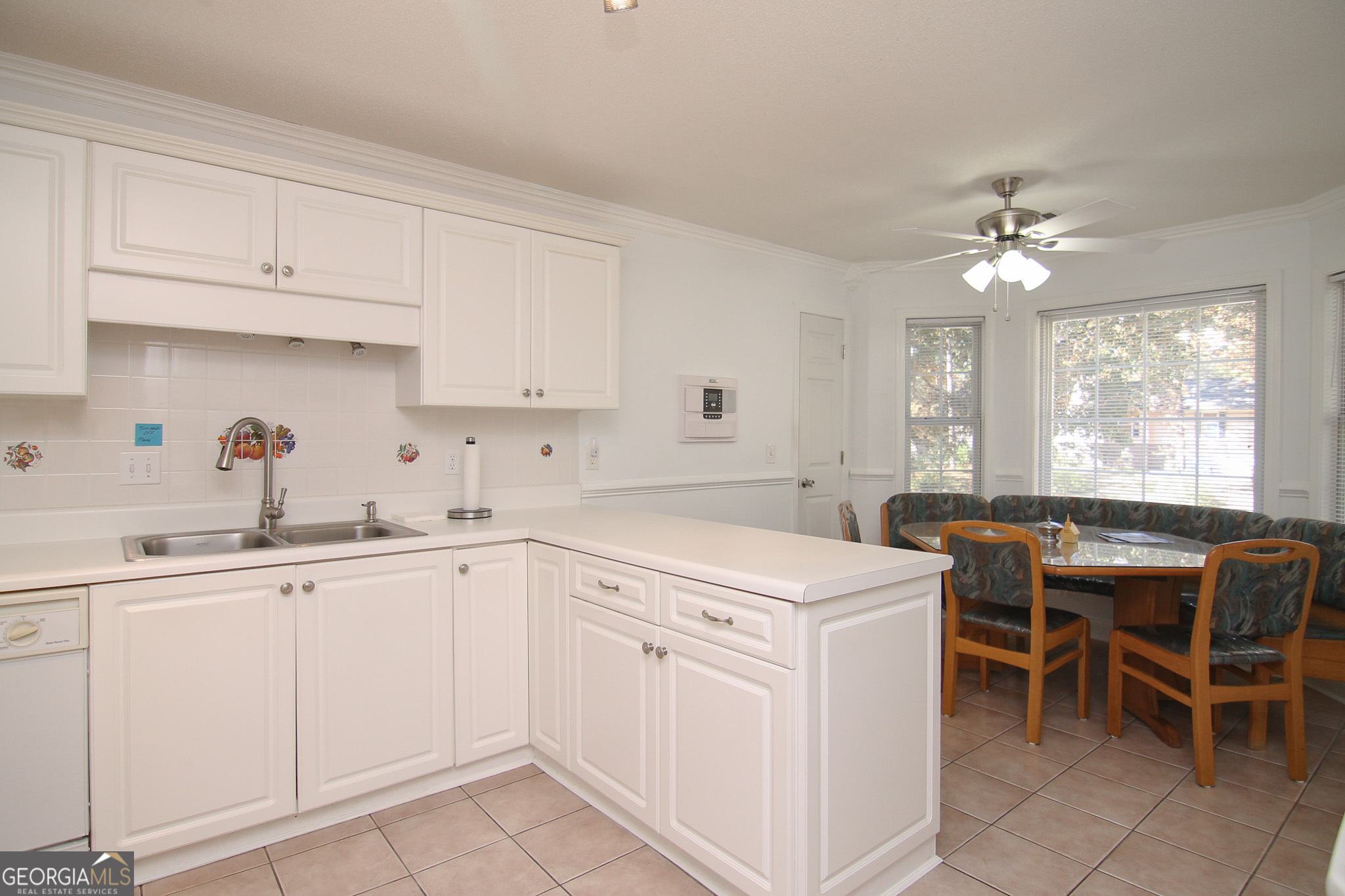 111 Maple Glen Centerville, GA 31028 - Photo 10 of 35 a kitchen that has a sink and a stove with white countertops