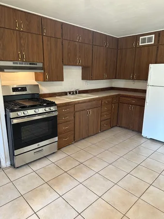 a kitchen with a cabinets and a stove top oven